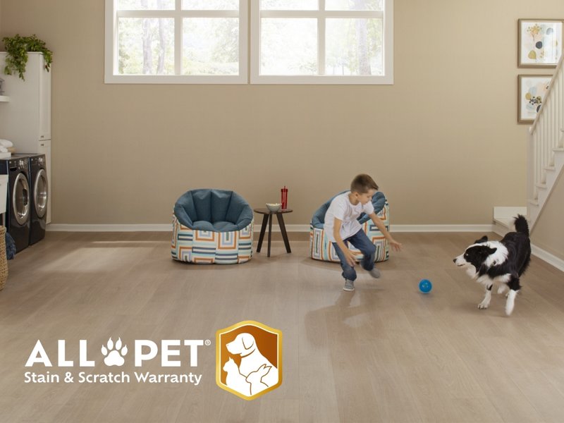 Mohawk Flooring All Pet Ad featuring a child and dog playing in an open room